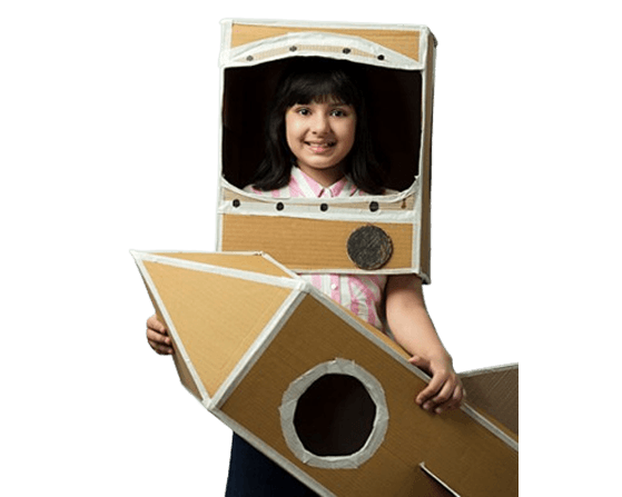 Child in a cardboard rocket costume at Queen Mira International School
